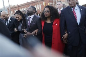 Oprah Winfrey locks arms with David Oyelowo, left, who portrays Martin Luther King Jr. in the movie. COURTESY Associated Press.